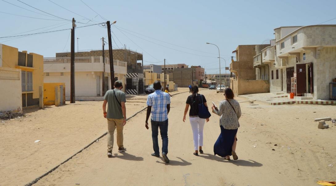 Projects Abroad interns walk through a local town as part of their Human Rights work experience in Senegal. Students walk through a local community during their Human Rights internship in Senegal.